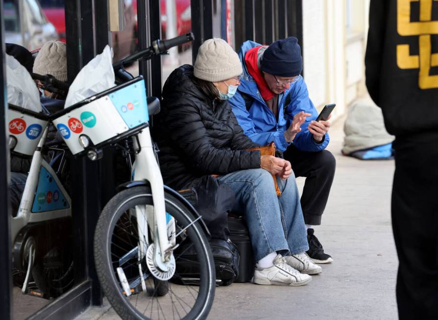 Richard Birmingham helps an unidentified woman get a room for a couple nights during his daily ...