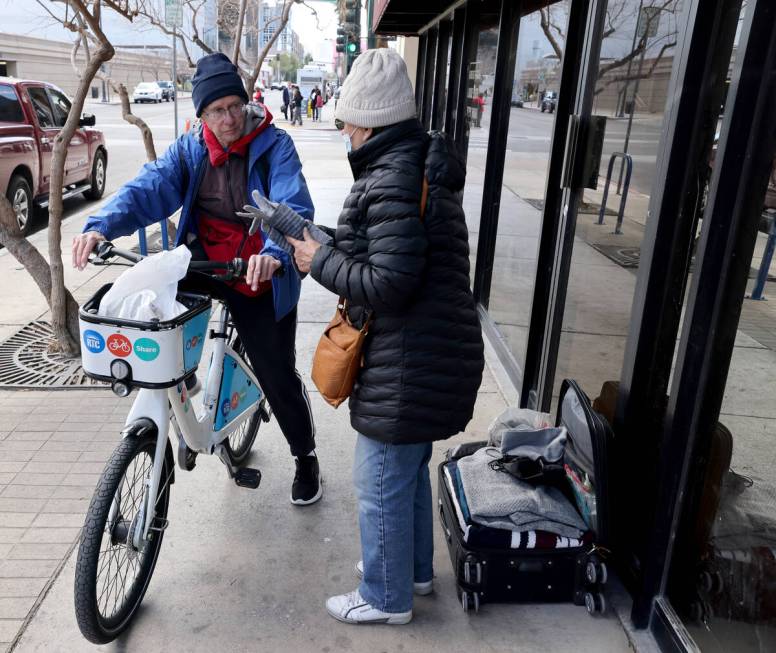 Richard Birmingham visits an unidentified woman during his daily bicycle outreach ride in downt ...