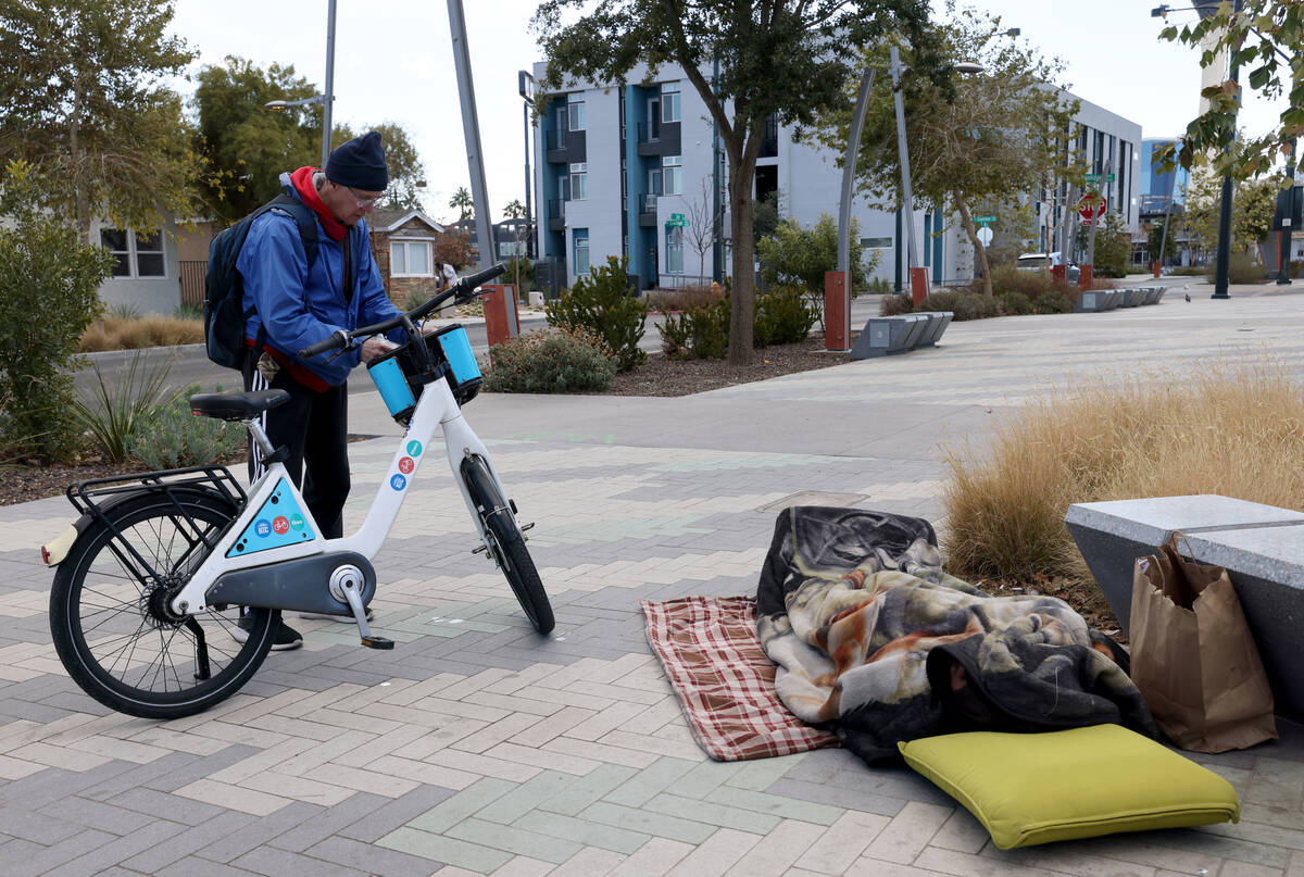 Richard Birmingham prepares to offer food during his daily bicycle outreach ride in downtown La ...