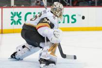 Vegas Golden Knights goaltender Logan Thompson makes the save against the New Jersey Devils dur ...