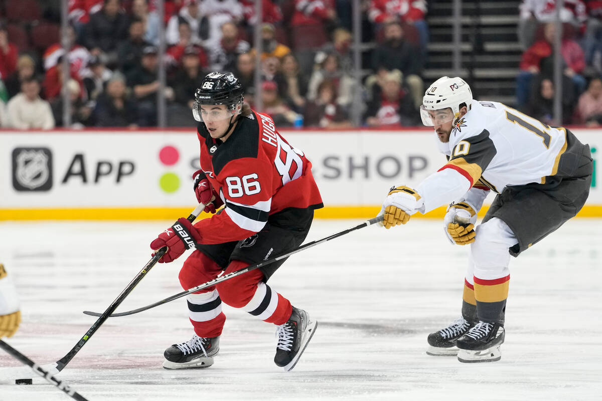 New Jersey Devils center Jack Hughes (86) skates past Vegas Golden Knights center Nicolas Roy ( ...