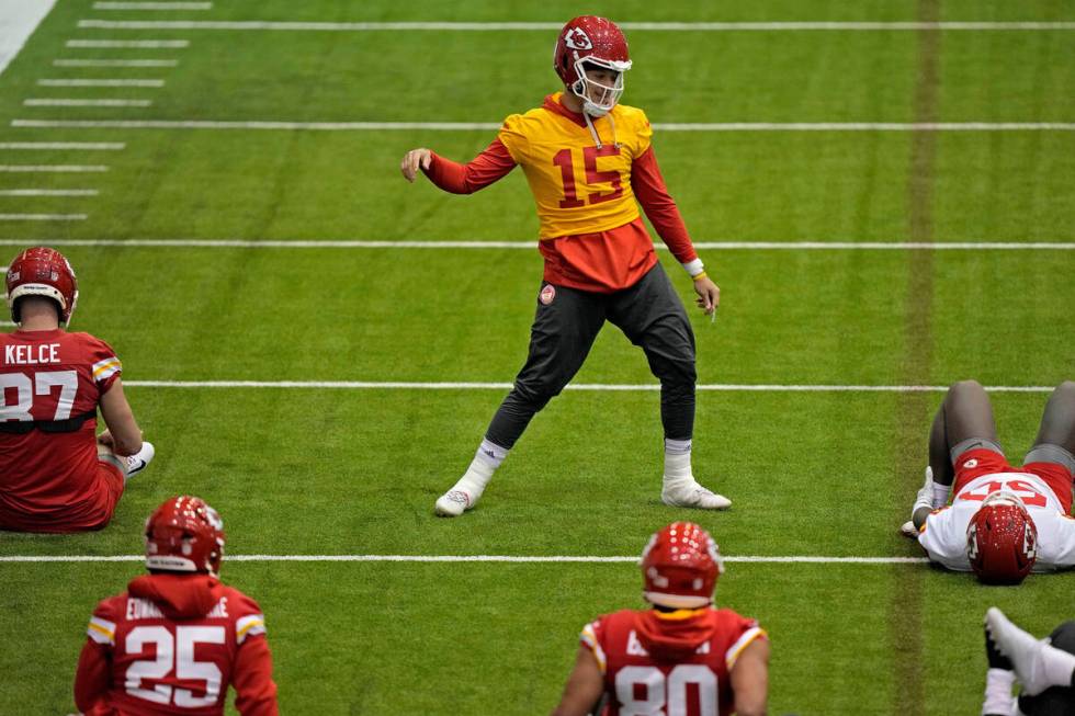 Kansas City Chiefs quarterback Patrick Mahomes (15) stretches with teammates during an NFL foot ...