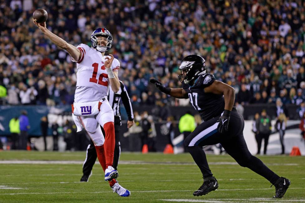 New York Giants quarterback Davis Webb (12) gets a pass off before being hit by Philadelphia Ea ...