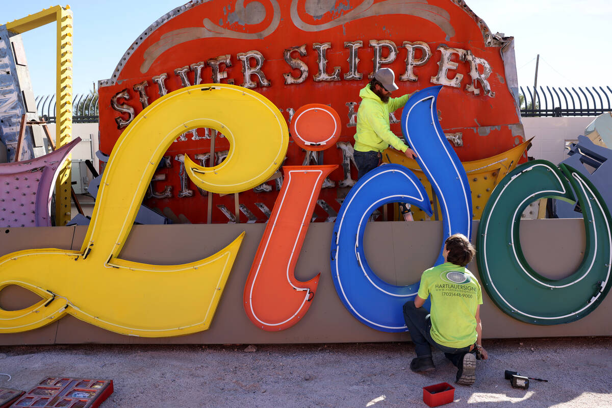 Zack Sawyer, top, and Levi “Bird” Mix with Hartlauer Signs restore the Lido de Pa ...