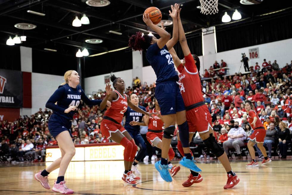 Nevada Wolf Pack forward Lexie Givens (23) shoots against UNLV Lady Rebels forward Alyssa Brown ...