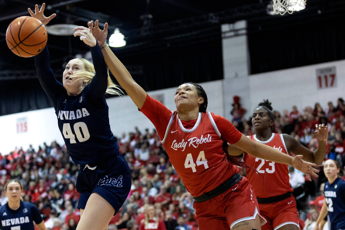 UNLV Lady Rebels forward Alyssa Brown (44) blocks Nevada Wolf Pack forward Megan Ormiston (40) ...