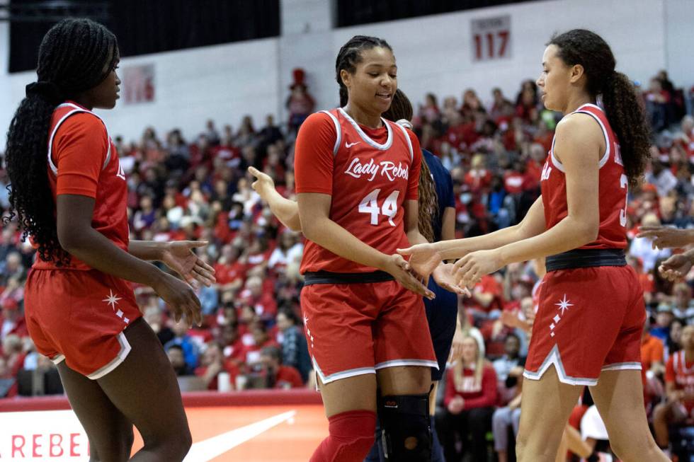 UNLV Lady Rebels forward Alyssa Brown (44) slaps hands with guard Jasmyn Lott, left, and guard ...