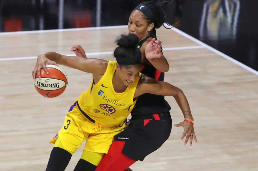 Los Angeles Sparks' Candace Parker (3) drives against Las Vegas Aces' A'ja Wilson during the se ...