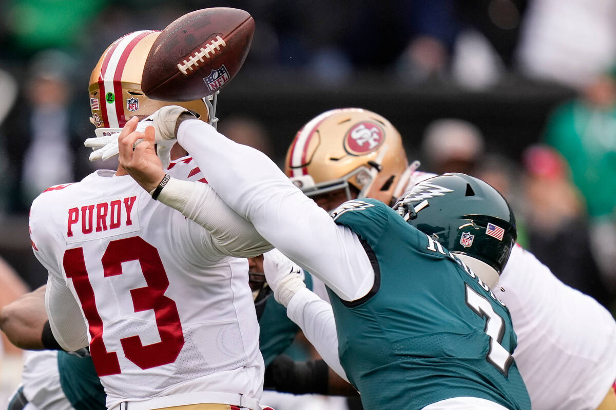 Philadelphia Eagles linebacker Haason Reddick, right, causes a fumble by San Francisco 49ers qu ...