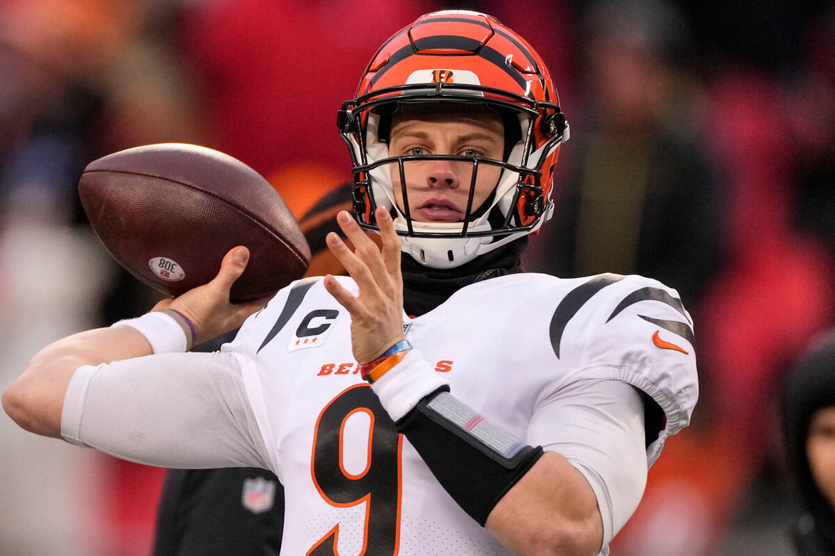 Cincinnati Bengals quarterback Joe Burrow warms up before the NFL AFC Championship playoff foot ...