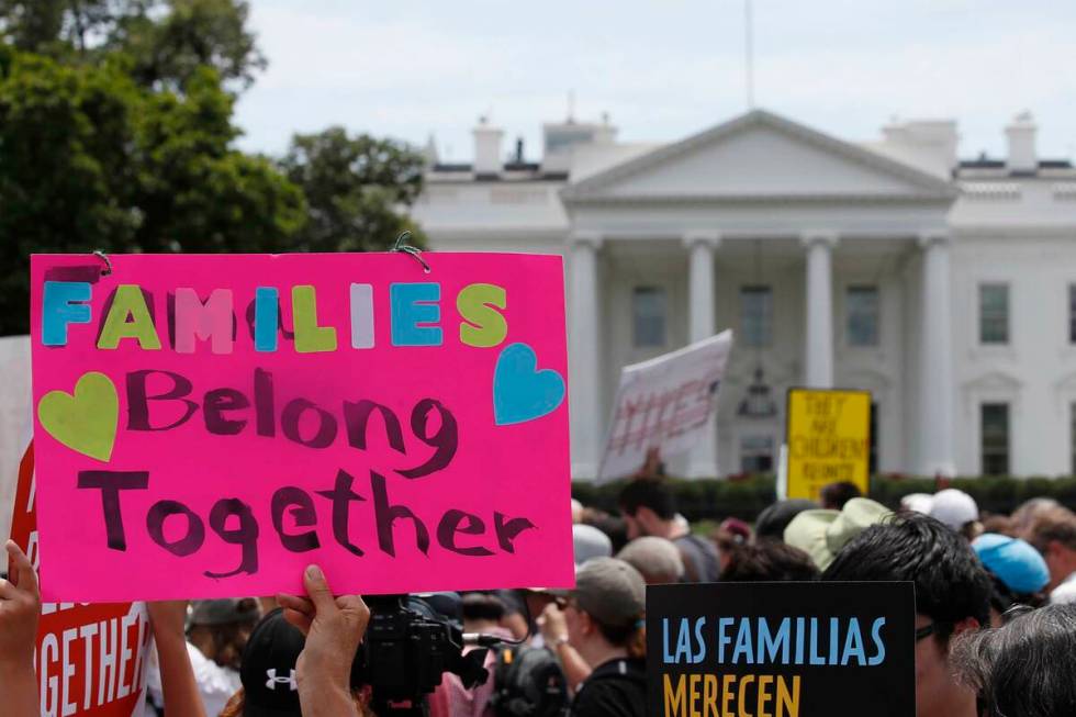 In this June 20, 2018, file photo, activists march past the White House to protest the Trump ad ...