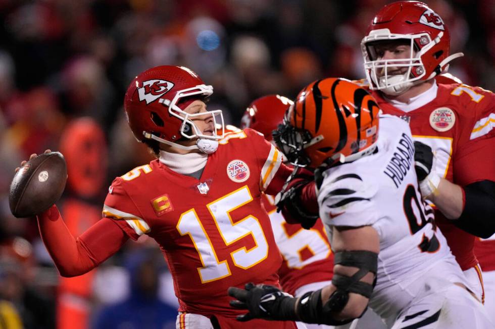 Kansas City Chiefs quarterback Patrick Mahomes (15) passes under pressure from the Cincinnati B ...