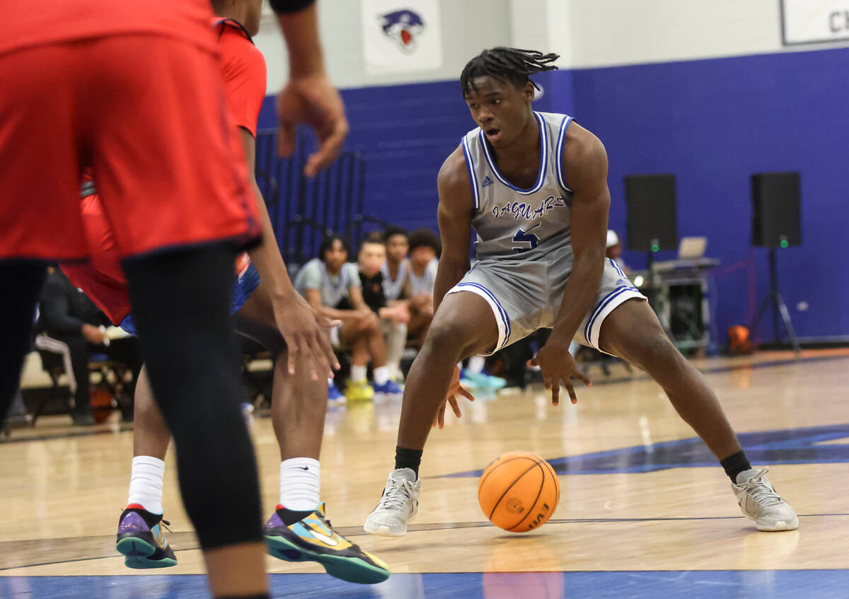 Desert Pines' Greg Burrell (5) brings the ball up court against Coronado during the first half ...