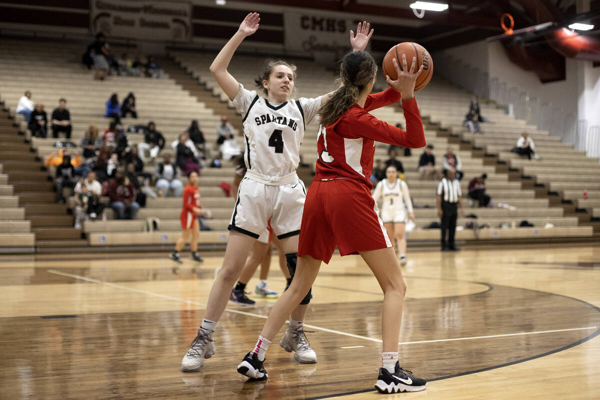 Cimarron-Memorial’s Kayley Israel (4) guards Doral’s Peyton Gomez (13) during a g ...