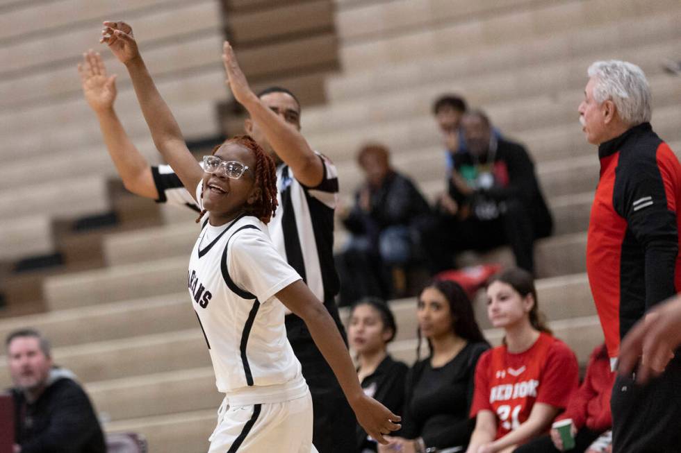 Cimarron-Memorial’s Dazani Graham celebrates after shooting a three-pointer during a gir ...