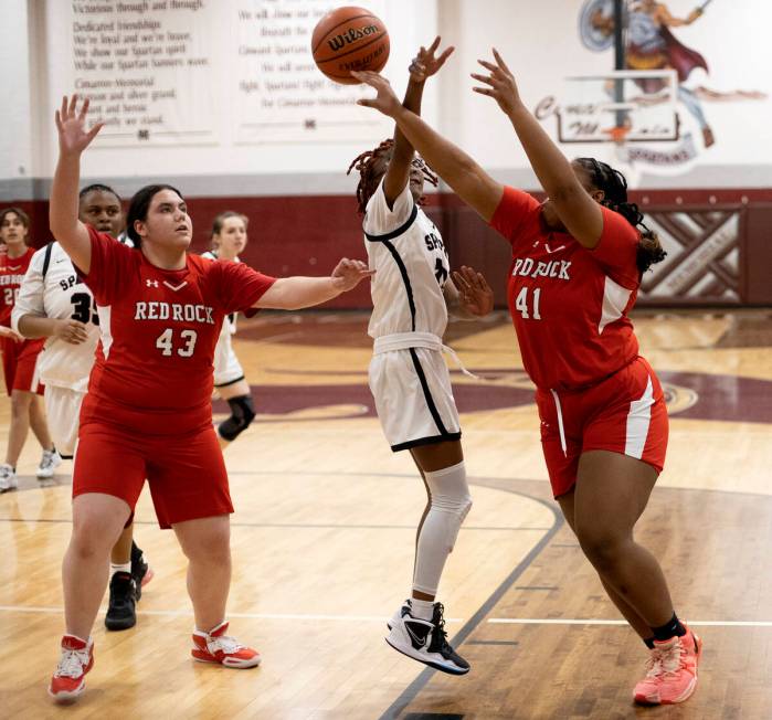 Doral’s Nyema Watkins (41) shoots while Cimarron-Memorial’s Dazani Graham, center ...