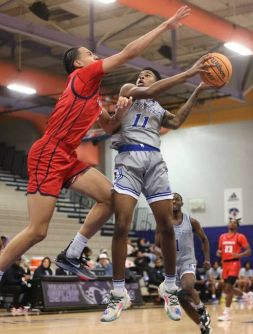 Desert Pines' Evan Tatum (11) tries to shoot around Coronado's forward JC Brooks, left, during ...