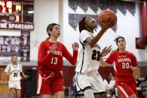 Cimarron-Memorial’s Dazani Graham (23) shoots against Doral’s Peyton Gomez (13) a ...