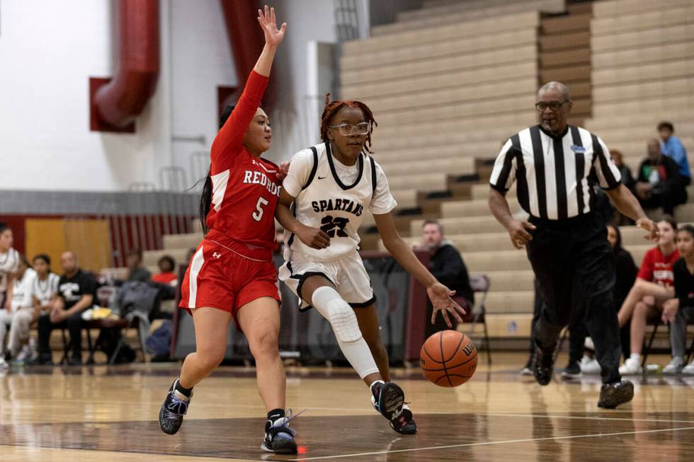 Cimarron-Memorial’s Dazani Graham (23) dribbles to shoot against Doral’s Ryann Ca ...