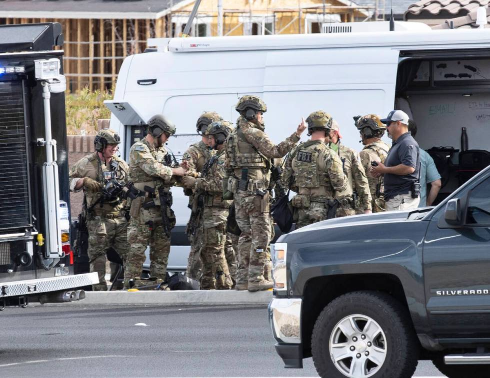A SWAT team arrives where Las Vegas police are assisting the Federal Bureau of Investigation in ...
