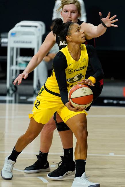 Seattle Storm forward Alysha Clark (32) shoots in front of Las Vegas Aces center Carolyn Swords ...