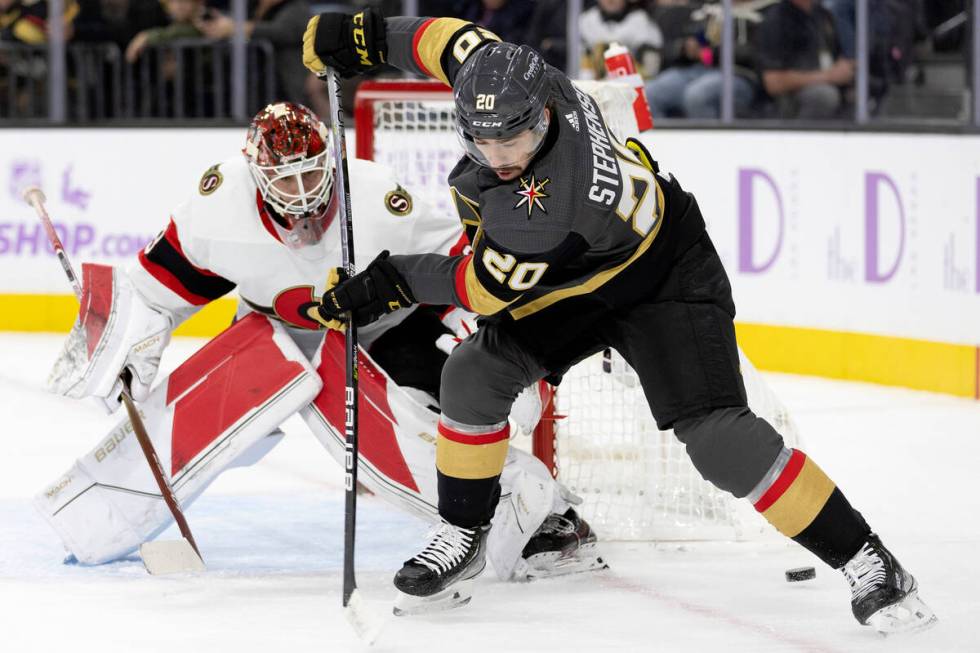 Golden Knights center Chandler Stephenson (20) misses a pass while Senators goaltender Cam Talb ...