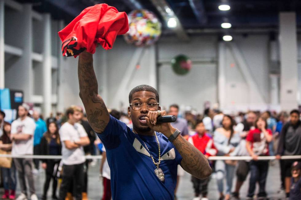 Cordero Brady, aka "CJ so Cool" hands out free tee shirts during Sneaker Con at the Las Vegas C ...