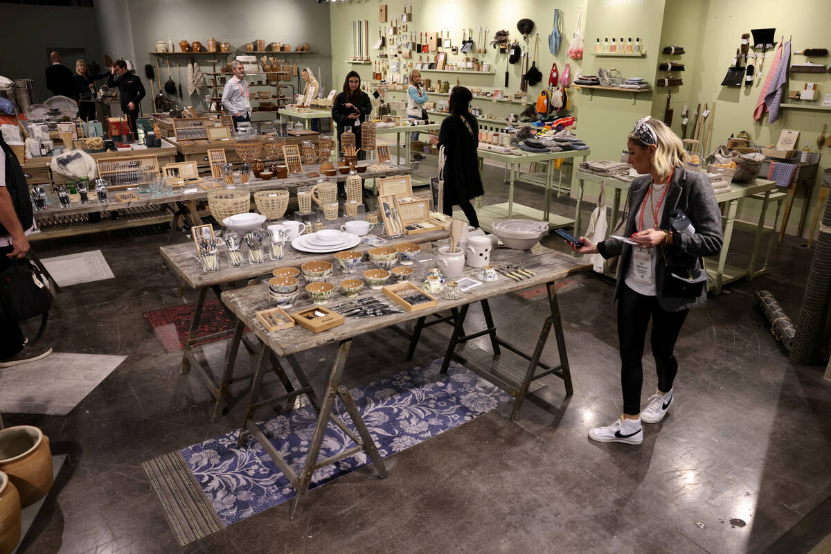 Conventioneers browse in the Kiss That Frog housewares showroom during the biannual Las Vegas M ...