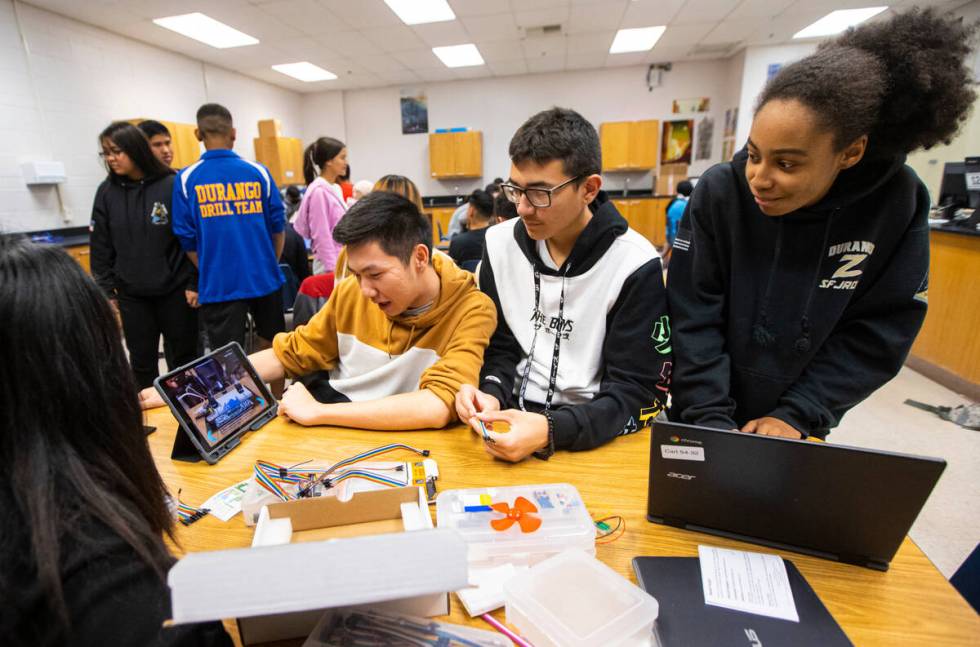 From left, senior James Phan, sophomore Keoni Johnson and sophomore Princess Hackett work with ...