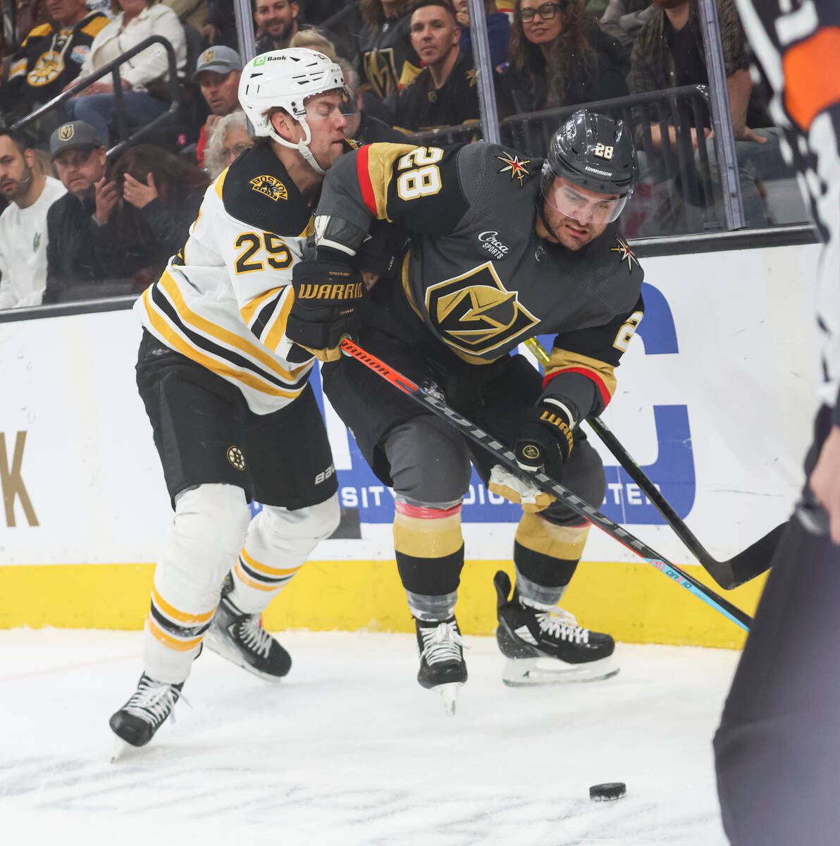 Golden Knights left wing William Carrier (28) and Boston Bruins defenseman Brandon Carlo (25) b ...