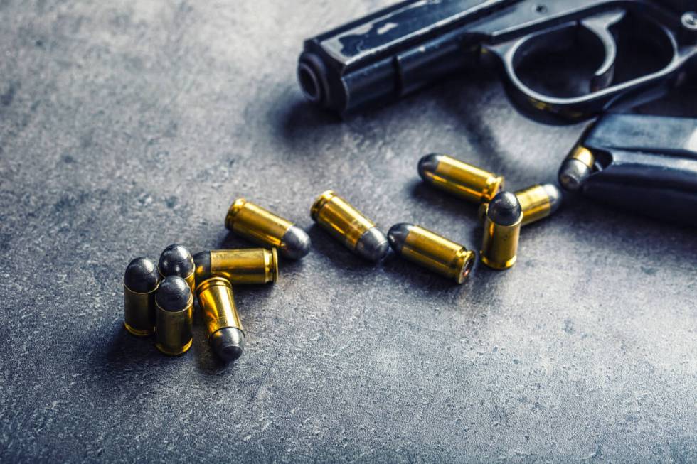 9mm pistol gun and bullets strewn on the table