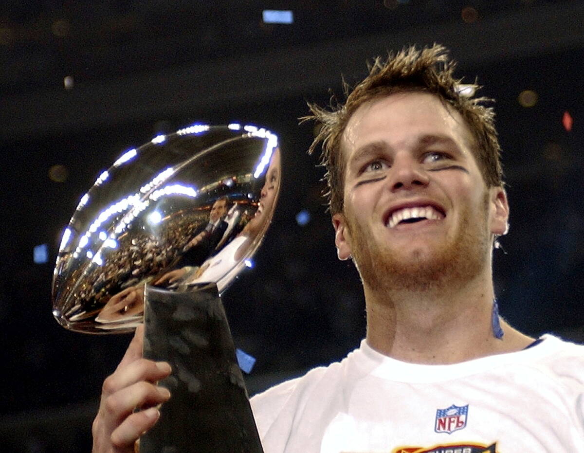 FILE - In this Feb. 1, 2004, file photo, New England Patriots quarterback Tom Brady holds the V ...