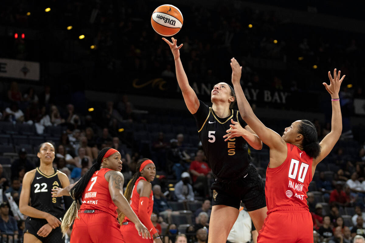 Las Vegas Aces forward Dearica Hamby (5) shoots against Atlanta Dream forward Naz Hillmon (00) ...