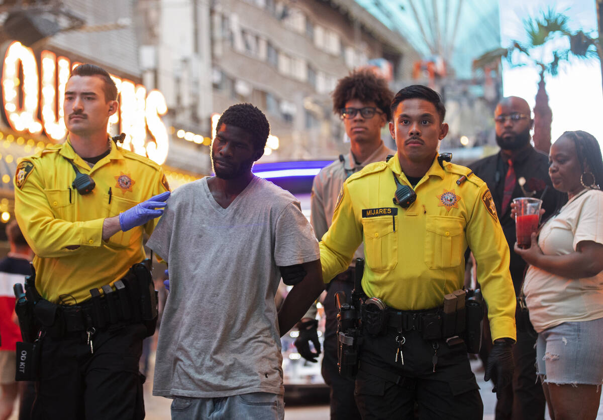 Las Vegas Metro officers detain a suspect at the Fremont Street Experience on Saturday, July 9, ...