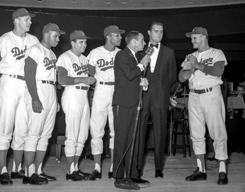 Joey Bishop performs on stage with Los Angeles Dodgers, from left, Frank Howard (25), Tommy Dav ...