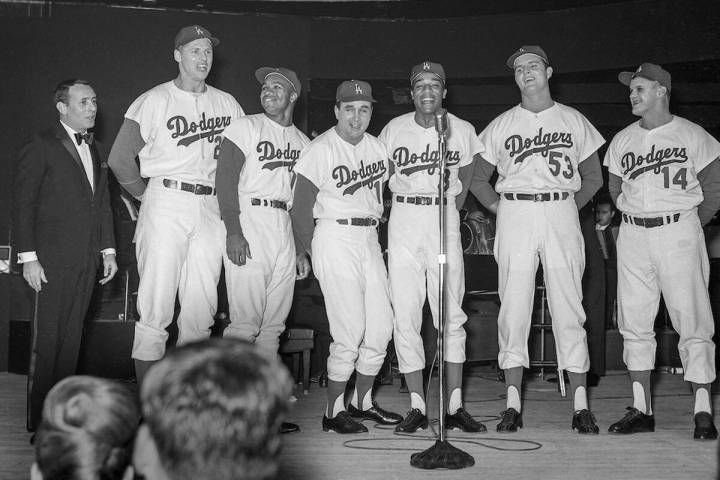 Joey Bishop performs on stage with Los Angeles Dodgers, from left, Frank Howard (25), Tommy Dav ...