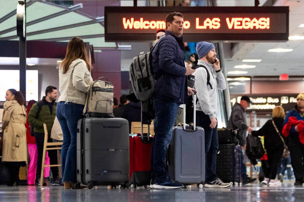 People arrive to the baggage claim area of Terminal 1 at Harry Reid International Airport in La ...