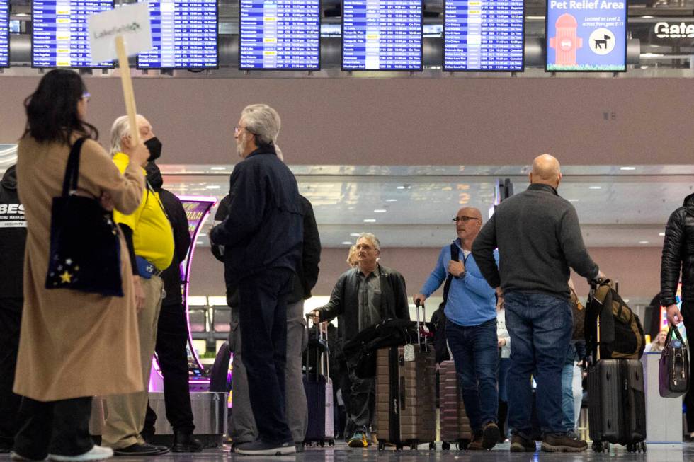 People arrive to the baggage claim area of Terminal 1 at Harry Reid International Airport in La ...