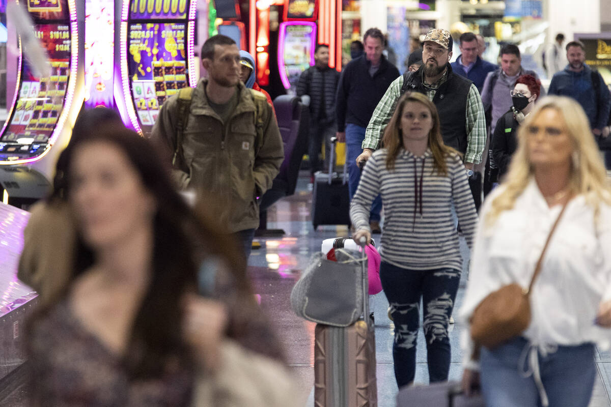 People arrive to the baggage claim area of Terminal 1 at Harry Reid International Airport in La ...