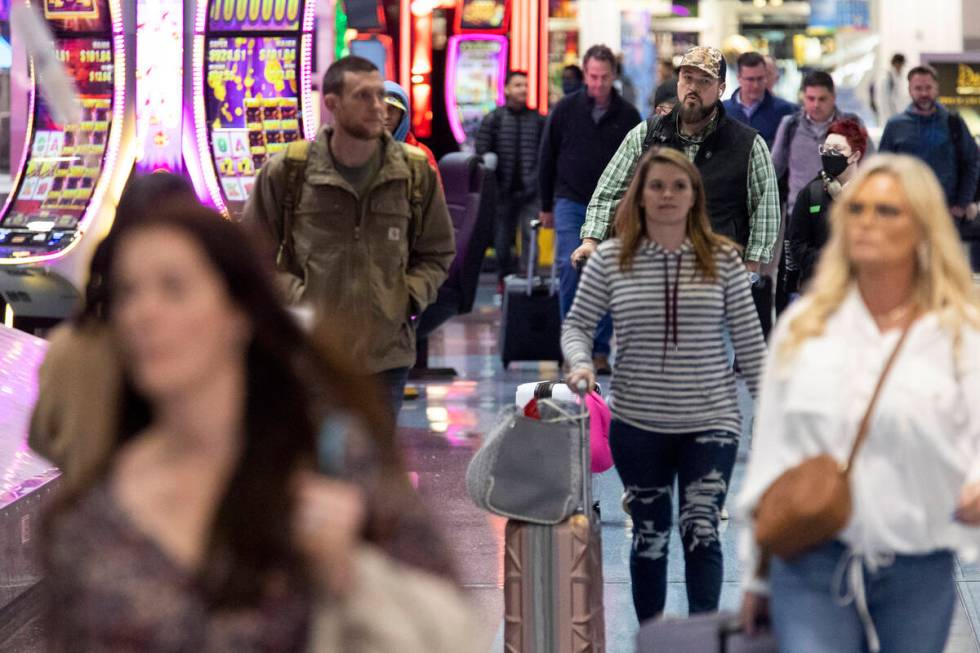 People arrive to the baggage claim area of Terminal 1 at Harry Reid International Airport in La ...