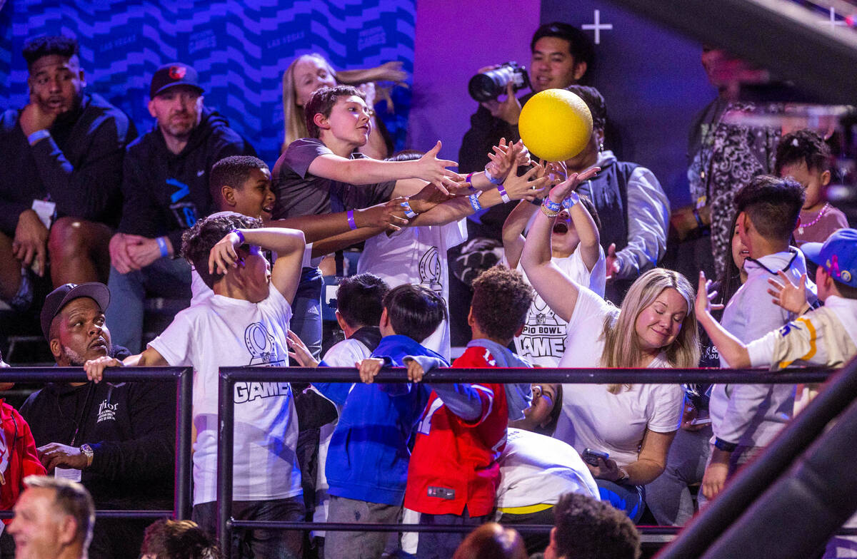 Fans reach for a ball tossed by a player before a round of dodgeball during the 2023 Pro Bowl G ...