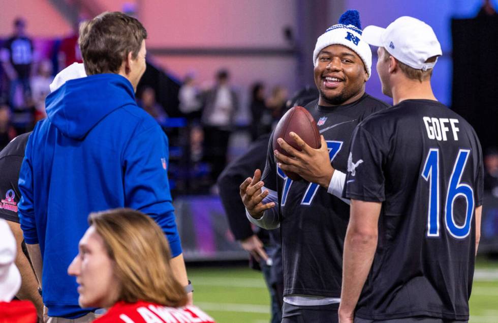 The NFC's Dexter Lawrence (97) of the Giants chats with Jared Goff (16) of the Lions during the ...