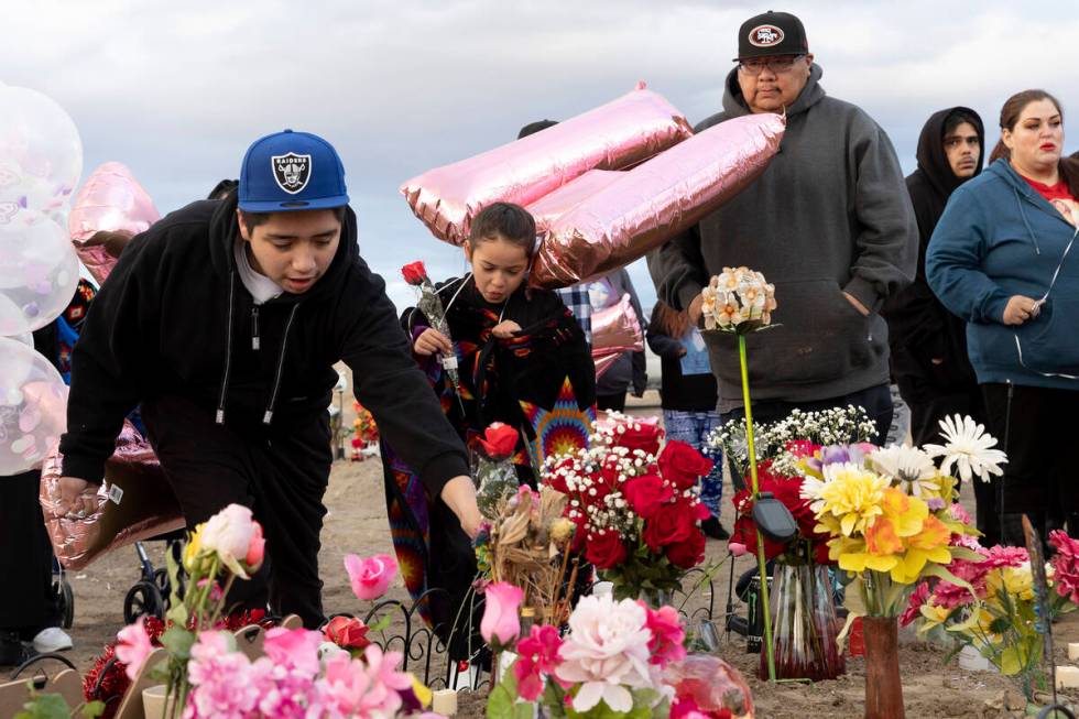 Loved ones of Anna Scott, a member of the Pyramid Lake Paiute Tribe, place flowers and mementos ...