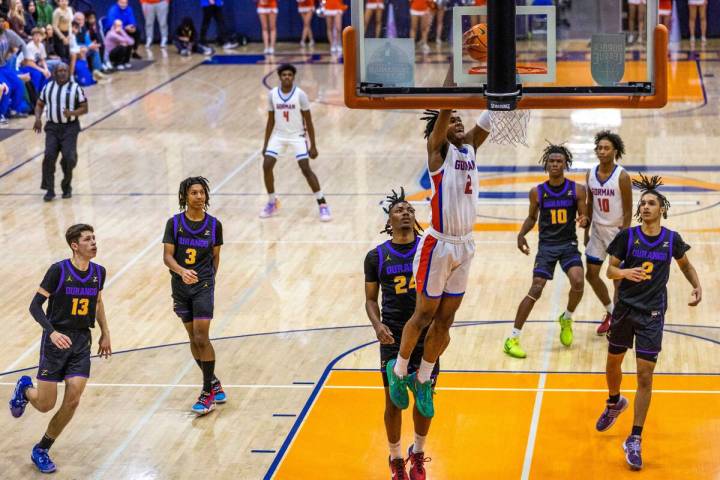 Bishop Gorman guard Keenan Bey (2) dunks the ball over Durango guard Taj Degourville (24) and ...