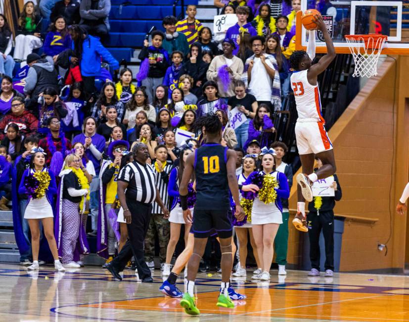 Bishop Gorman forward Christopher Nwuli (23) dunks the ball over Durango during the first half ...