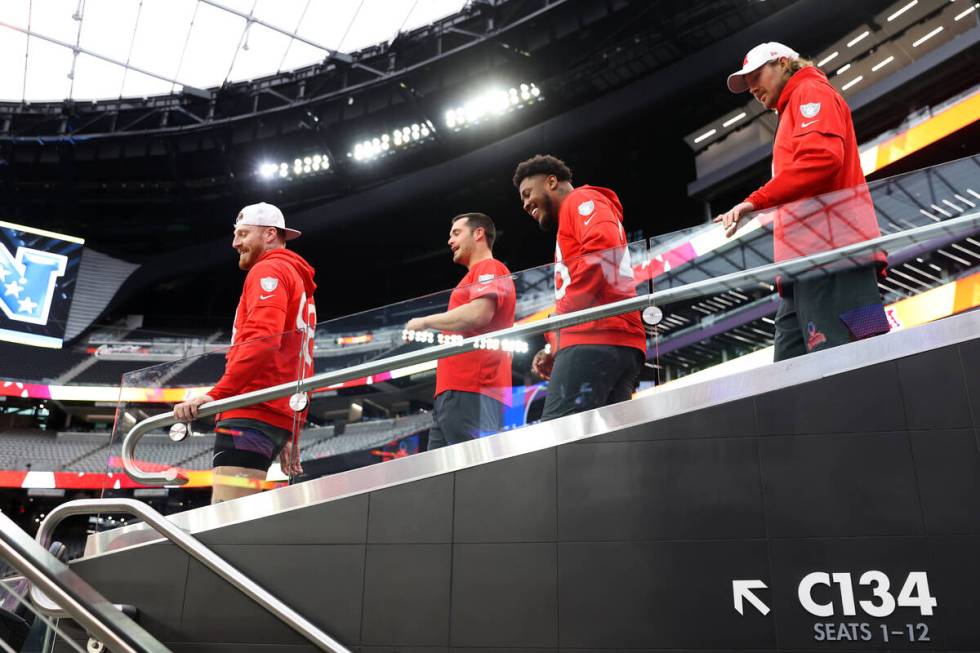 Las Vegas Raiders defensive end Maxx Crosby (98), from left, quarterback Derek Carr (4), runnin ...