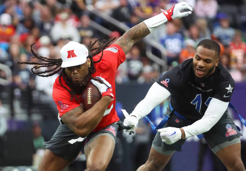 Dallas Cowboys outside linebacker Micah Parsons (11) pulls a flag from Tennesse Titans running ...