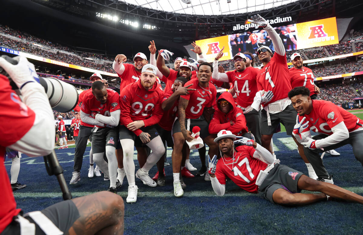 Members of the AFC team, including honorary captain Snoop Dogg, lower left, pose for a photo wh ...