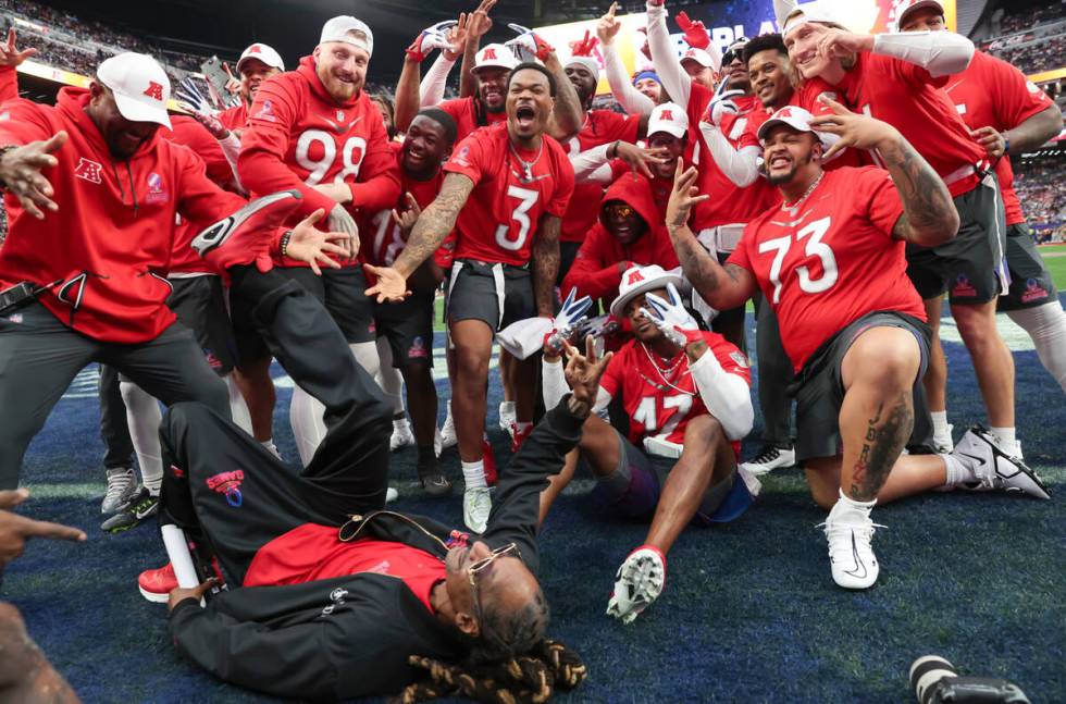 Members of the AFC team, including honorary captain Snoop Dogg, lower left, pose for a photo wh ...