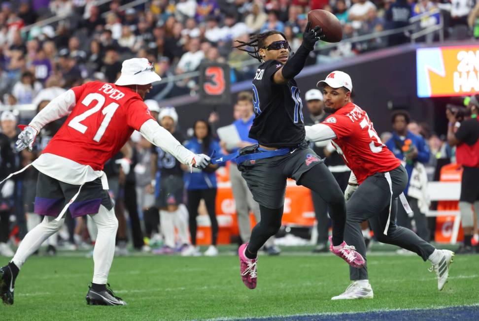 Minnesota Vikings wide receiver Justin Jefferson (18) gets his flag pulled by Buffalo Bills str ...